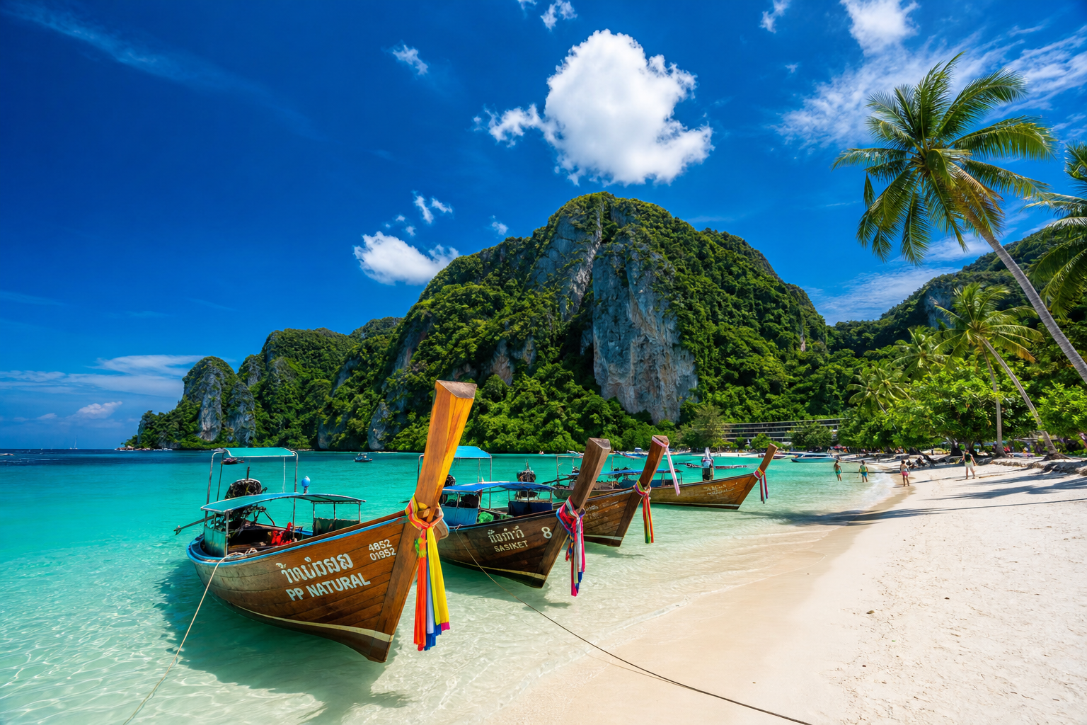 Phuket tropical beach with longtail boats and turquoise water